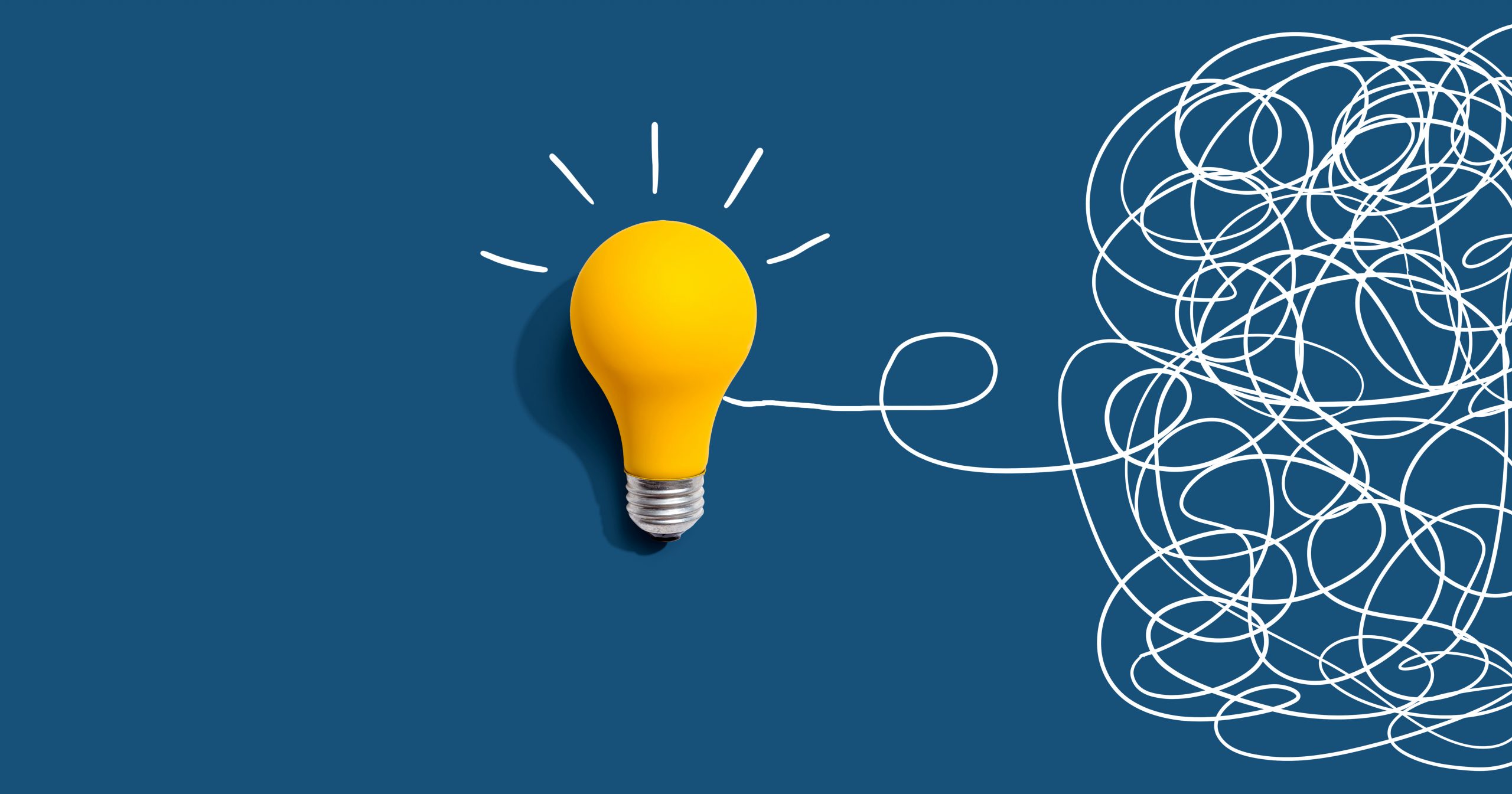 Bright lightbulb beside a mass of looping white lines, representing clarity or problem-solving from a complicated situation
