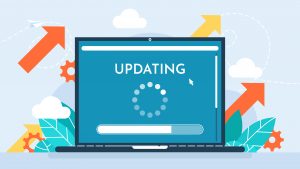laptop screen showing the word ‘Updating’ with a loading spinner and progress bar