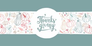 Hand drawn banner saying Happy Thanksgiving" with drawings of cute pumpkins, leaves and hearts.