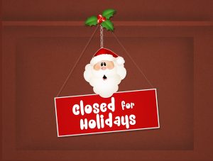 Santa plaque on front door with sign saying closed for holidays